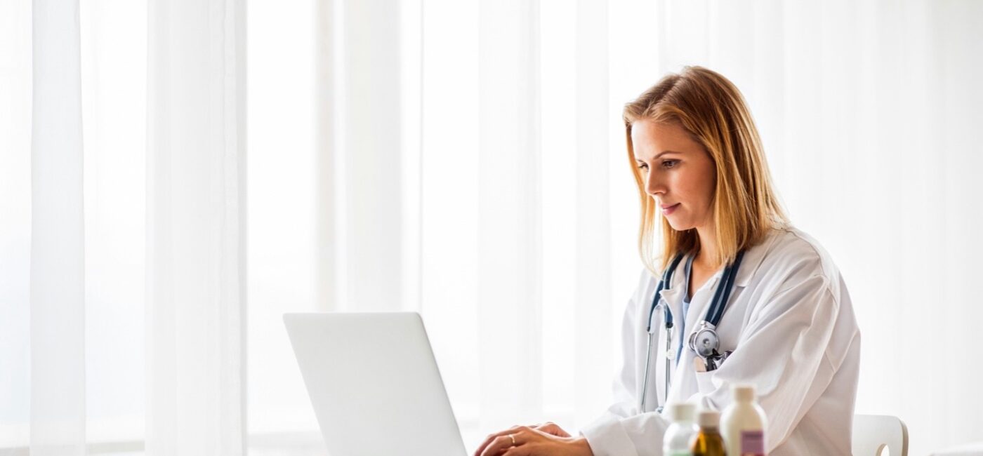 Nurse practitioner calculating the cost to open an NP practice at her desk