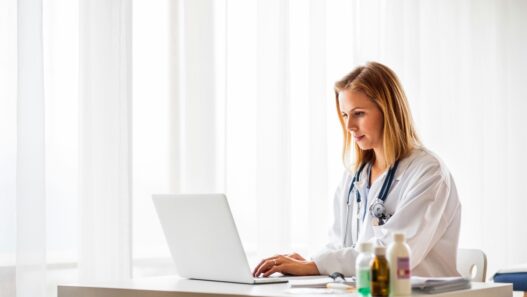 Nurse practitioner calculating the cost to open an NP practice at her desk