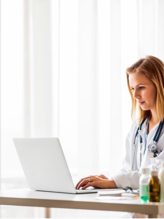 Nurse practitioner calculating the cost to open an NP practice at her desk