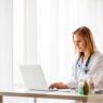 Nurse practitioner calculating the cost to open an NP practice at her desk