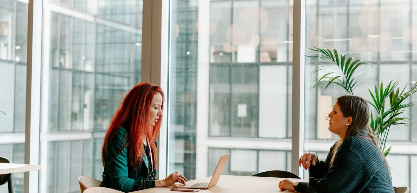 Two nurse practitioners discussing a solo or partner practice decision at a desk