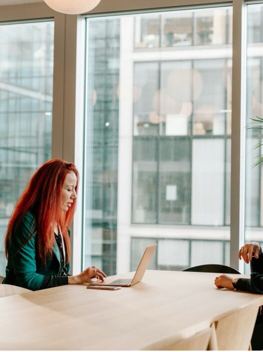 Two nurse practitioners discussing a solo or partner practice decision at a desk
